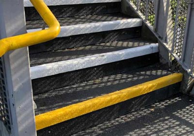 Close-up of slip-resistant stair nosing installed on commercial stairs