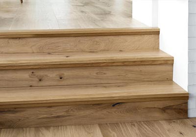 Close-up of wood effect stair nosing blending with modern interior design